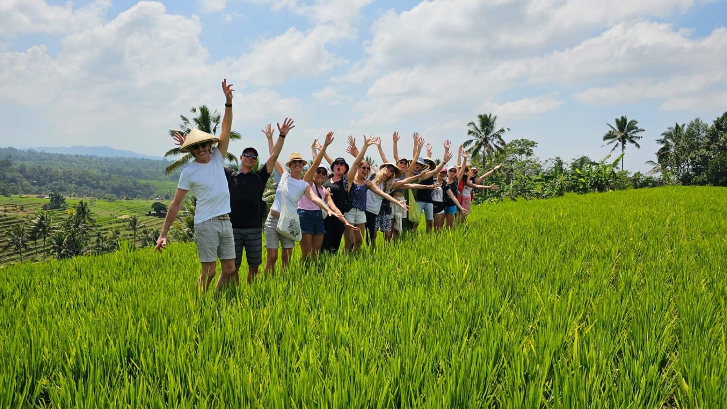 Yoga Bali students immerse in Balinese rice fields, exploring culture during their teacher training.