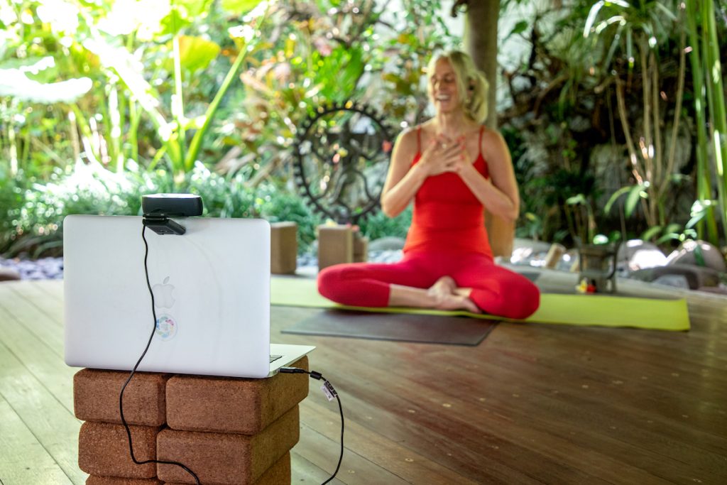 Beate guides an online yoga session, connecting practitioners worldwide.