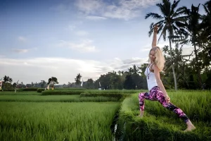 Beate übt Yoga inmitten der friedlichen Reisfelder Balis – eine ideale Kulisse für dein 200-stündiges Yogalehrer-Training oder eine 300-stündige Yogalehrer-Ausbildung mit Retreat.
